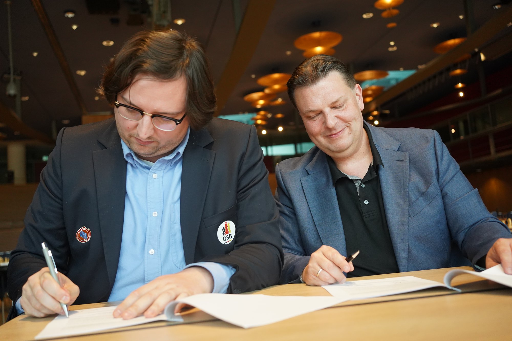 Beide Unterzeichner beim Unterschreiben der Verträge